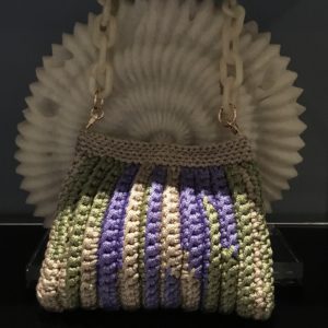Add a touch of handmade charm to your look with this one-of-a-kind crochet handbag accessory for carrying your essentials while adding a pop of style to any outfit. Handmade with love and care, this bag is sure to turn heads and spark conversation wherever you go. Order now and make a statement with this charming crochet creation!